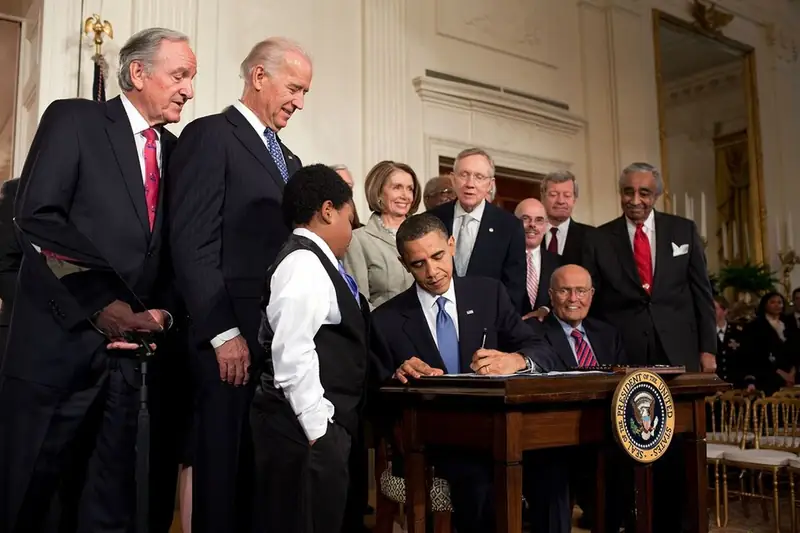 President Obama signs a health-care bill, March 2010.